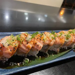 a close up of a sushi roll on a blue plate