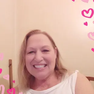 a smiling woman in a white shirt