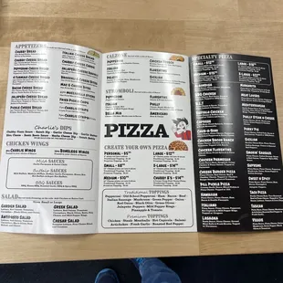 a menu and a person's feet