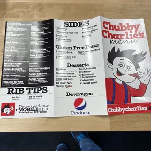 a menu and a person's feet