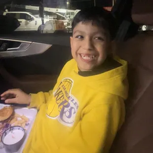 a young boy sitting in a car