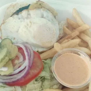 Cheeseburger with fried egg on top and spicy ranch