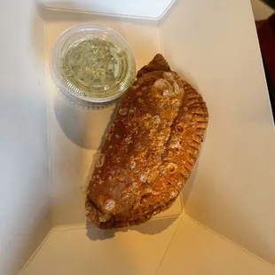 a piece of pie with a side of salsa