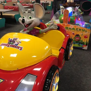 a mouse driving a toy car