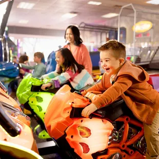 a young boy riding a toy motorcycle