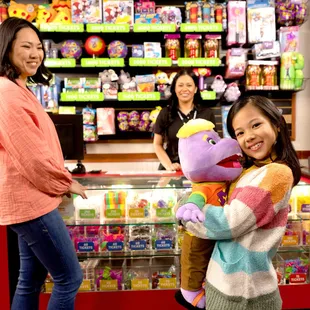 a girl holding a stuffed animal
