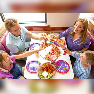 a family eating pizza
