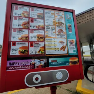 a happy hour menu displayed on a sign