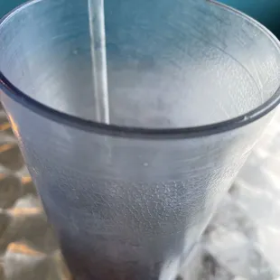 a drink being poured into a glass
