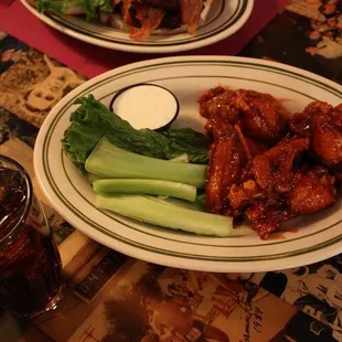 a plate of chicken wings and broccoli