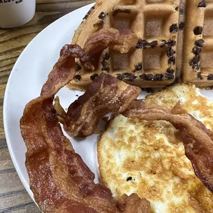 Chocolate chip Belgium waffle, bacon, and over hard eggs