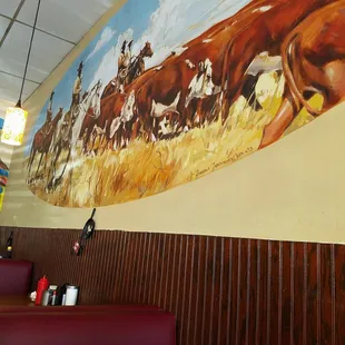 Mural on one of the walls. Cowboys doing what they do.