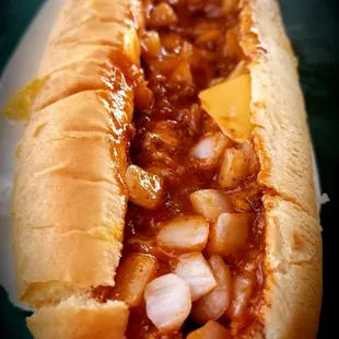 Chili cheese dog, added mustard and onion..