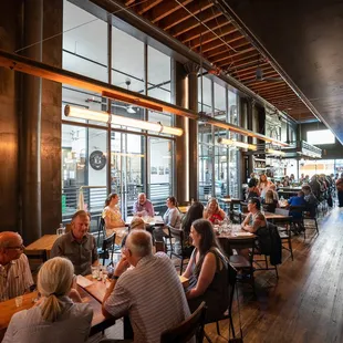 Dining area of Penny Farthing with view into the distillery brew space.