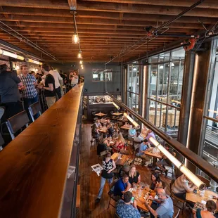 View of mezzanine bar, downstairs dining area, and distillery.