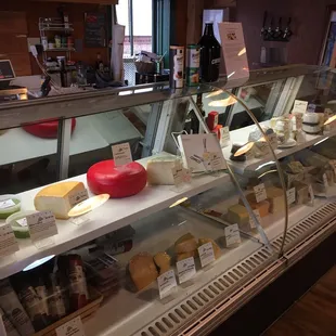 Cheese fridge w/ a few dip selections and small cured meats section