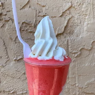 a hand holding a cup of ice cream