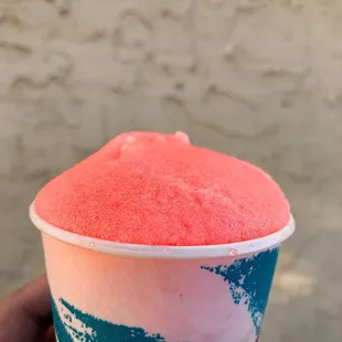 a hand holding a cup