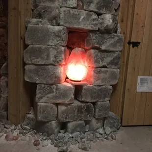 a brick fireplace with a lit candle