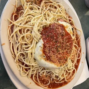 a plate of spaghetti with sauce and an egg