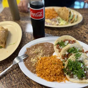 Three taco meal, one potato taco on the side and a Mexican Coke.