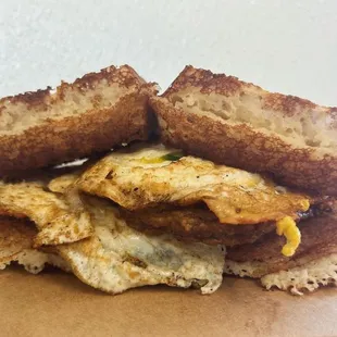 Breakfast sandwich on a housemade sourdough waffle with provolone, jalapenos &amp; sausage!