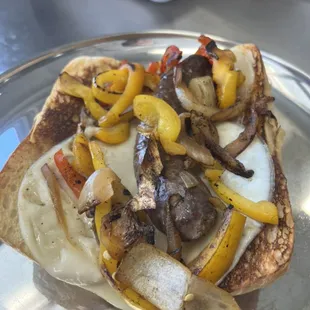 Grilled local grassfed sausage bun with grilled bell pepper, onion and provolone cheese