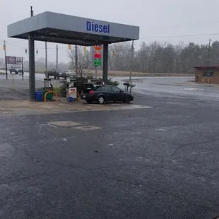 a car parked in front of a gas station