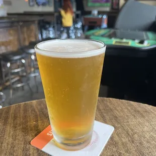 a pint of beer on a coaster