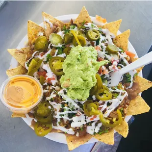 a plate of nachos with guacamole