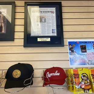 Hats for sale and above a framed newspaper article.