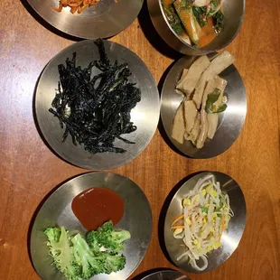 a variety of asian dishes on a wooden table