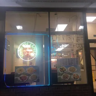 a neon sign in the window