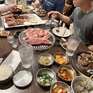 a group of people sitting at a table eating