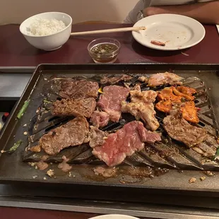 a grill with meat and vegetables