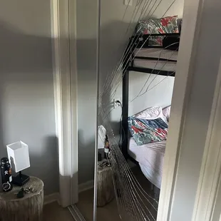 a broken mirror in a bedroom