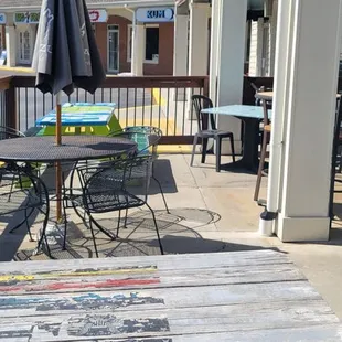 a patio with tables and chairs