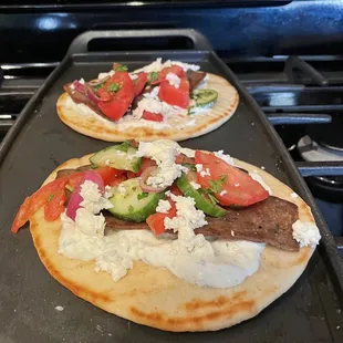 two flatbreads topped with various toppings