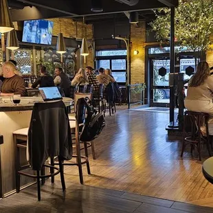 a group of people sitting at a bar