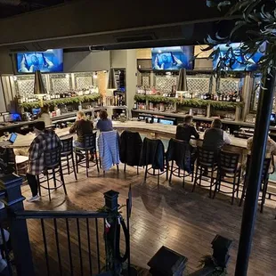 people sitting at tables in a restaurant
