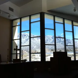 We worship at the foot of the Sandia Mountains.