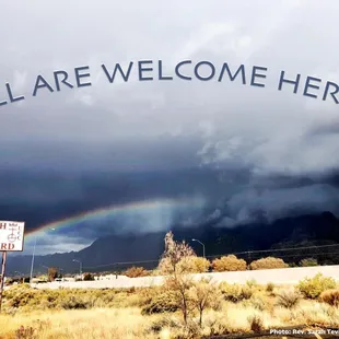 View from the parking lot with rainbow over the Sandias