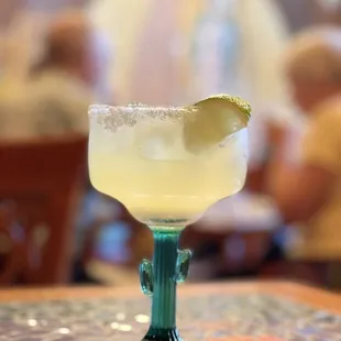 a margarita with a slice of lime on the rim