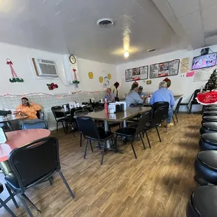 people sitting at tables and eating