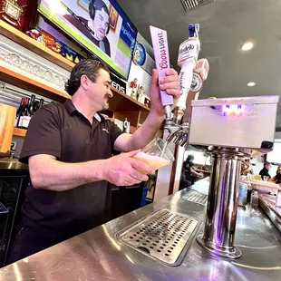 a man pouring a beer