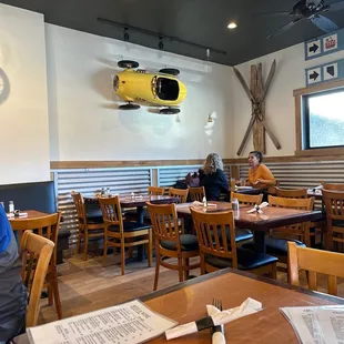 people sitting at tables in a restaurant