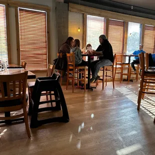 people sitting at tables in a restaurant