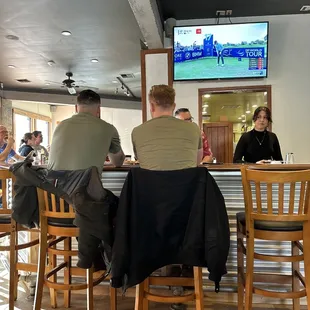 a group of people sitting at a bar