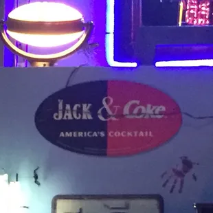 a neon sign for jack and five american's cocktail
