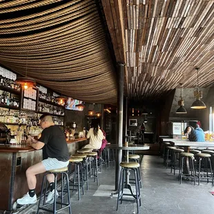 a man sitting at a bar in a restaurant